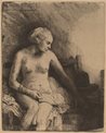 Woman at the bath with a hat beside her by Rembrandt